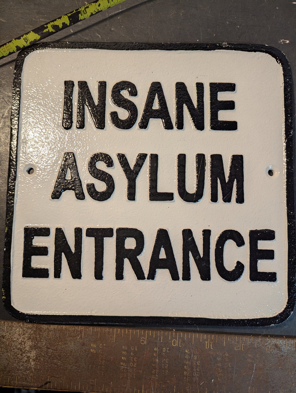 White large cast iron insane asylum entrance sign