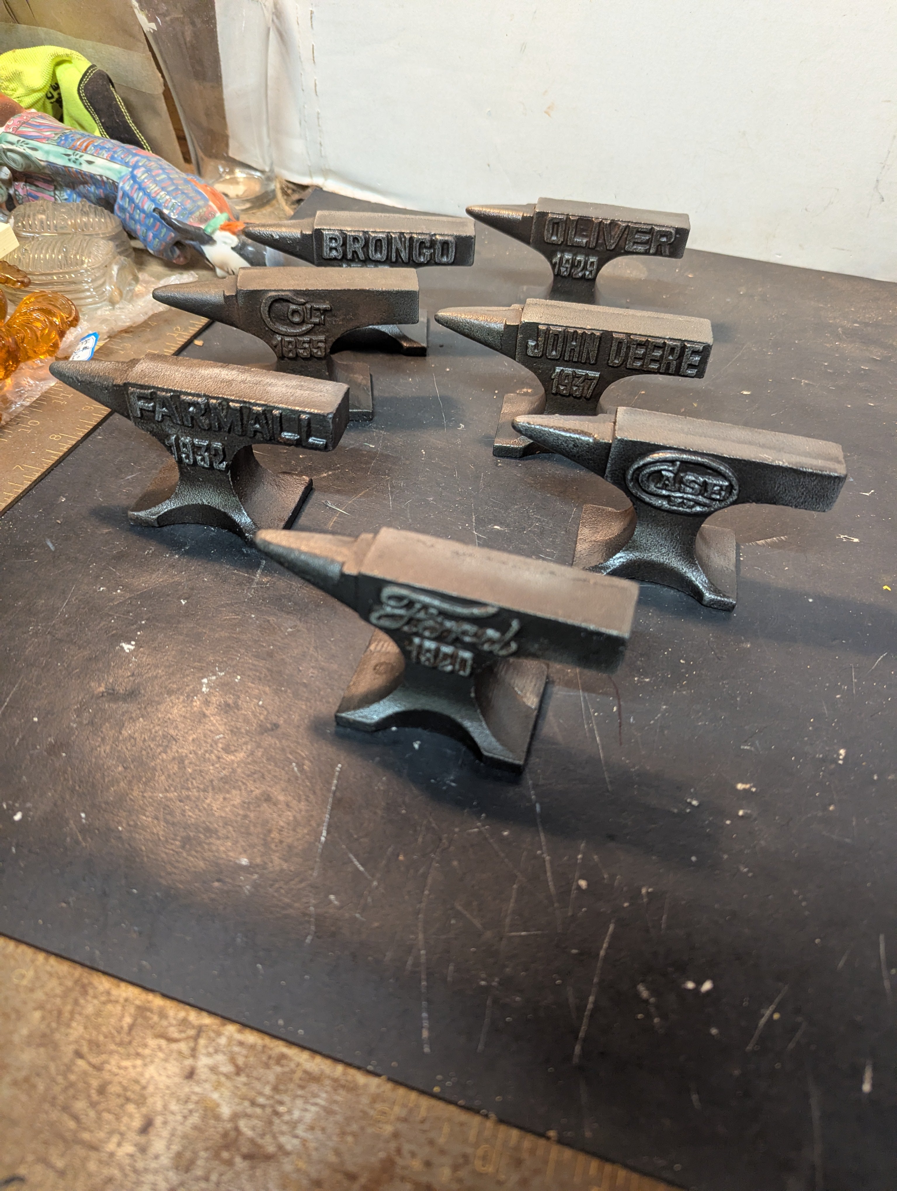 Seven  miniature advertising anvils