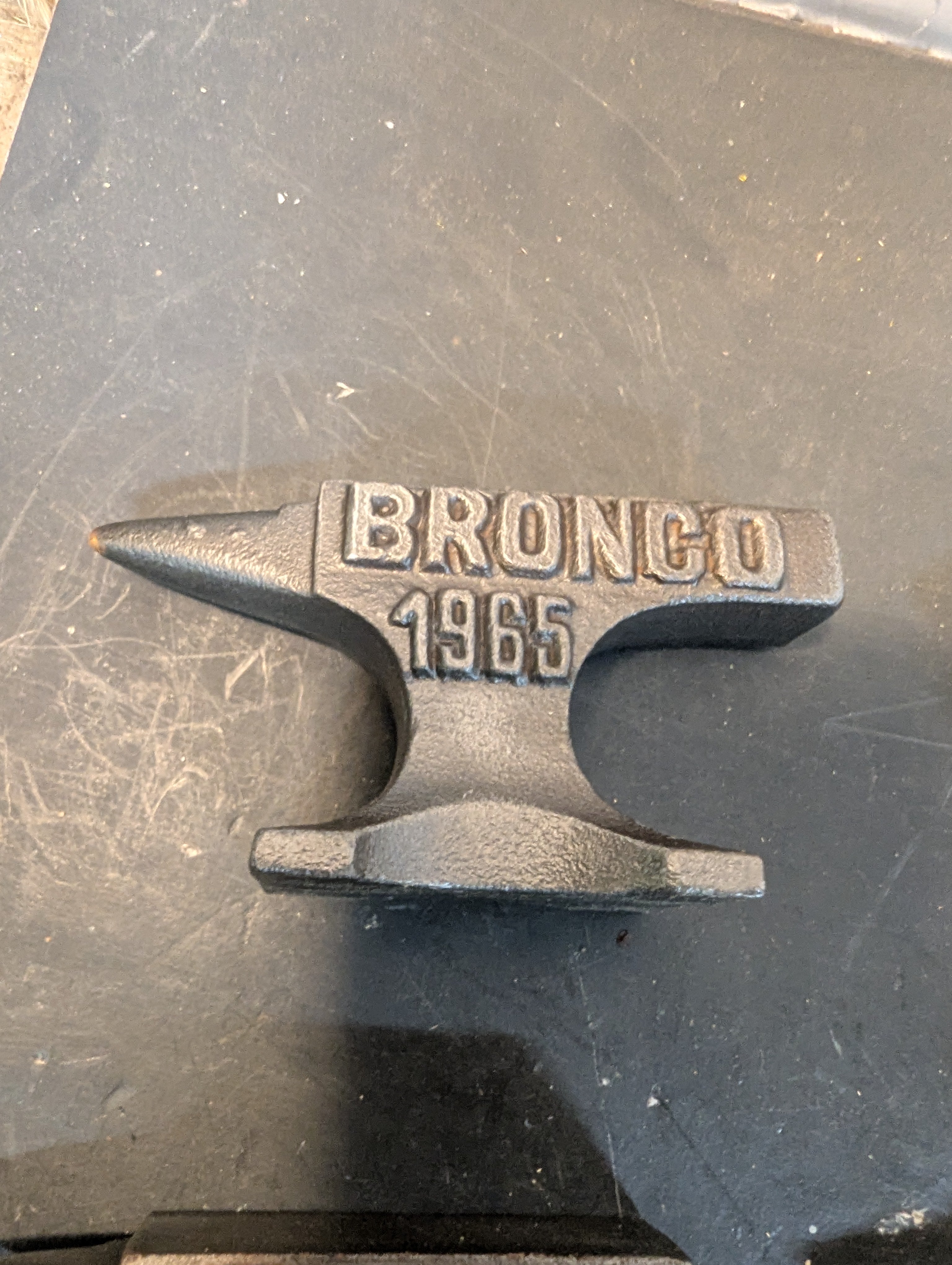 Seven  miniature advertising anvils